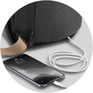 A black bag with a charging port and a white charging cable connected to a smartphone.