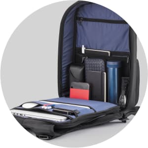 A navy blue Flex Gym Bag with multiple compartments holding a drink bottle, notebooks, and other accessories.