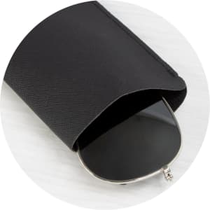 A black sunglass pouch partially covering a pair of dark sunglasses, featuring a logo.
