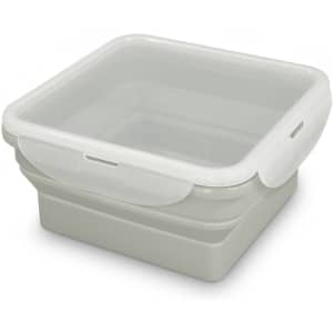 A grey collapsible lunch box with a clear lid, featuring a logo on the side.