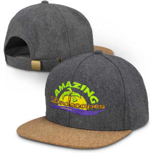 A grey flat peak cap with a cork brim and an embroidered logo featuring vibrant tropical scenery.