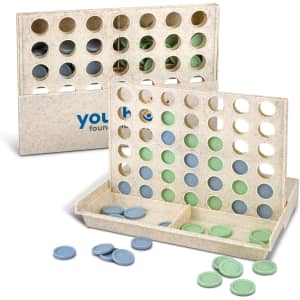 A Four in a Row game set featuring a light-coloured board with blue and green discs scattered around.
