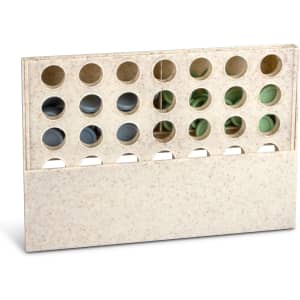 A Four in a Row game in a cream-coloured frame with multiple holes for game pieces.