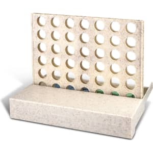 A light-coloured board game with a vertical grid and circular holes for placing game pieces.