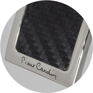 A sleek key ring featuring a textured black surface and a metallic silver frame, with branding.