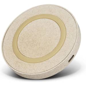 A round, beige wireless charger with a gold accent and a small port on the side, featuring a logo.