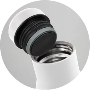 A drink bottle in white with a black lid, featuring a stainless steel interior and a step-up cap design.