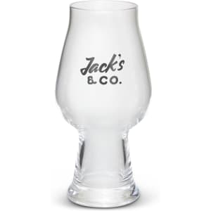 A clear, curved beer glass with a thick base and a printed logo on the front.