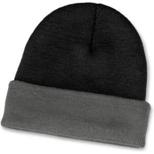 A two-toned beanie featuring black and grey hues with a folded cuff. It has a logo on the design.