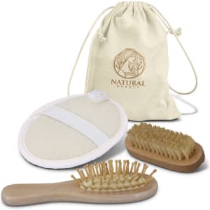 A natural beauty travel set featuring a canvas pouch, a body brush, a hairbrush, and a cleansing pad.