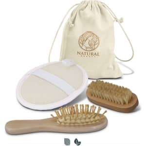 A natural beauty travel set including a brush, exfoliating mitt, and storage bag, featuring neutral tones.
