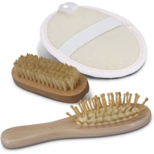 A travel set featuring a wooden hairbrush, a smaller wooden brush, and a round massage brush with a strap.