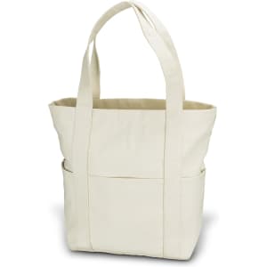 A beige canvas tote bag with two sturdy handles and an exterior pocket. It has a simple design and is unadorned.