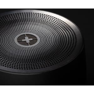 A black bass speaker featuring a perforated top surface and a logo.