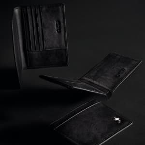 A black Swiss Peak Anti Skimming Wallet with multiple card slots, displayed from different angles against a dark background.