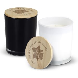 A black and white scented candle duo with wooden lids, featuring intricate designs on the lid.