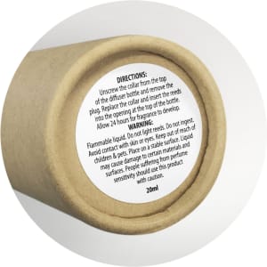 A cylindrical container for a scented diffuser, featuring a natural brown colour, with a warning label.