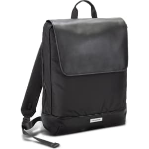 A sleek black backpack with a flap closure, featuring padded back straps and a brand logo on the front.