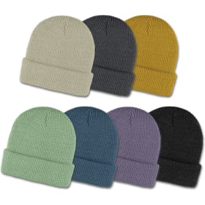 A collection of waffle beanies in various colours: cream, grey, mustard, green, blue, purple, and black. Each has a folded cuff.