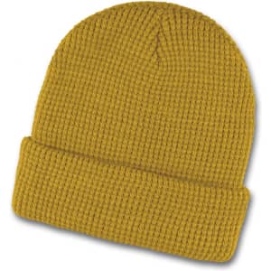 A mustard yellow waffle beanie featuring a ribbed texture and a folded cuff. It has a logo present.