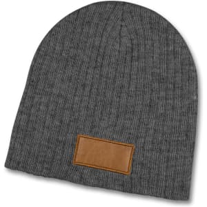 A grey cable knit beanie featuring a textured patch, designed for warmth and style.