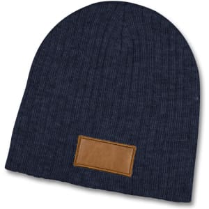 A navy blue cable knit beanie with a brown patch. The beanie has a textured pattern and is soft.
