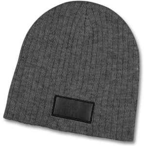 A grey cable knit beanie with a textured fabric and a patch.