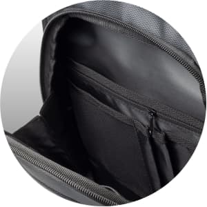 A close-up of the interior of a grey backpack featuring multiple pockets and a zippered compartment.