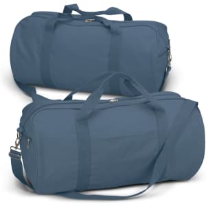 A canvas duffle bag in a deep blue shade, featuring dual handles and a detachable shoulder strap. It has a small front pocket and a logo.