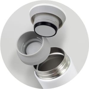 A drink bottle in white with a detachable grey lid, showcasing the interior opening and the lid's seal.