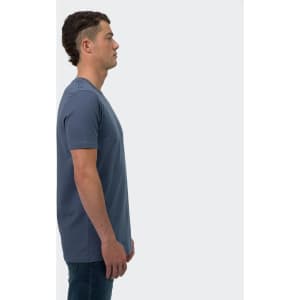 A male model stands in profile wearing a blue TRENDSWEAR Original men's T-shirt. The shirt features a logo.