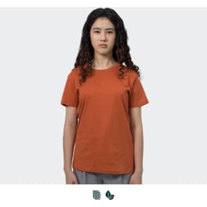 An orange women's T-shirt displayed on a model, featuring a simple design and a logo.