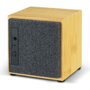 A square Bluetooth speaker in bamboo finish with a grey felt front, featuring input and reset buttons on the side.