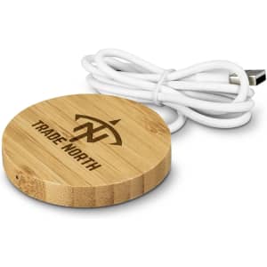 A round, bamboo wireless charger with a white USB cable, featuring a logo on the surface.