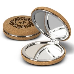 A cork compact mirror with a decorative design, featuring a shiny inner surface and a polished silver rim.