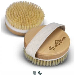A wooden body brush in natural wood with light bristles and a fabric strap, featuring a logo on the side.