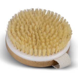 A round wooden body brush with natural bristles and a fabric strap on the side.