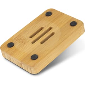 A bamboo soap holder with rounded edges and black rubber feet, featuring drainage grooves on the surface.