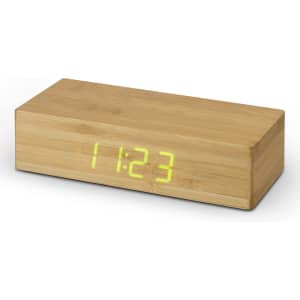 A bamboo wireless charging clock with a simple rectangular design and a digital display showing the time in green.