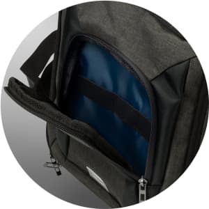 A cooler bag in dark grey featuring a zippered compartment and a blue insulated interior. It has a logo.