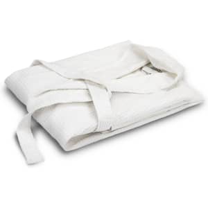 A folded white waffle bathrobe with a matching tie belt, featuring a textured fabric and branding.
