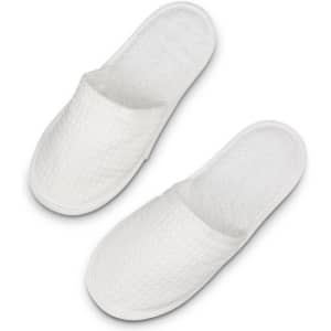 A pair of white waffle slippers with a textured surface and a soft, plush interior.