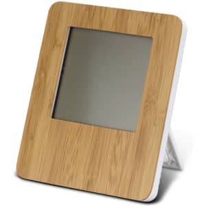A bamboo-framed weather station with a sleek design and a grey screen, standing on a foldable white support.