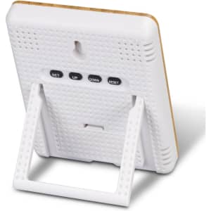 A bamboo and white weather station with buttons for setting and adjusting, featuring a foldable stand.