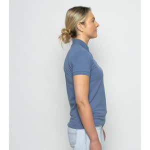 A side view of a blue women's polo shirt, featuring a collar and short sleeves, with a logo on the chest.