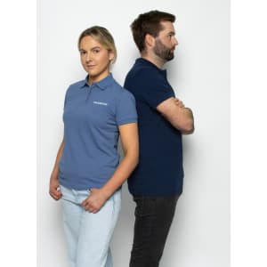 A blue women's polo shirt worn by a woman, paired with a navy polo shirt worn by a man, both standing back to back.