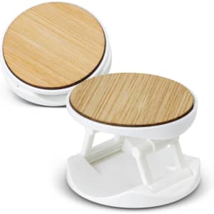 A bamboo and white phone holder with a sleek, modern design, featuring a circular bamboo surface.
