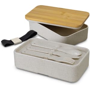 A stackable lunch box in light grey with a bamboo lid, featuring compartments and cutlery inside. It has a strap for secure closure.