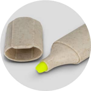 A highlighter with a yellow tip and a speckled beige body, featuring a removable cap and a minimalist design.