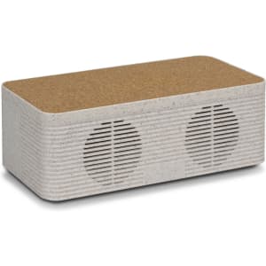 A wireless charger with a textured cork top and a light-coloured, speckled body, featuring dual speakers.